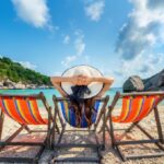 woman-with-hat-sitting-on-chairs-beach-in-beautiful-tropical-beach-woman-relaxing-on-tropical-beach-at-koh-nangyuan-island-780x470